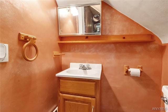 18 Spruce St, Lockport-City, NY 14094 - half bathroom featuring vanity, lofted ceiling, and toilet