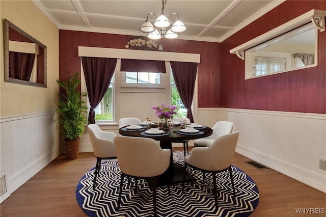 18 Spruce St, Lockport-City, NY 14094 - dining room featuring a chandelier, a wainscoted wall, wood finished floors, crown molding, and baseboards
