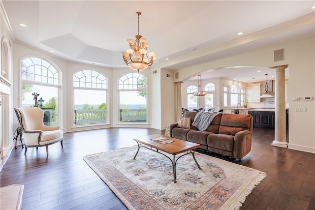 411 Sundance Trl, Webster, NY 14580 - living area featuring arched walkways, a chandelier, a raised ceiling, dark wood-type flooring, and baseboards