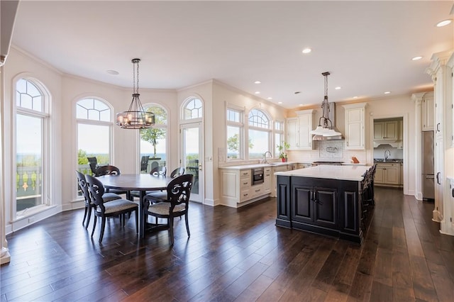 411 Sundance Trl, Webster, NY 14580 - kitchen with a sink, healthy amount of natural light, a kitchen island, ornamental molding, and recessed lighting