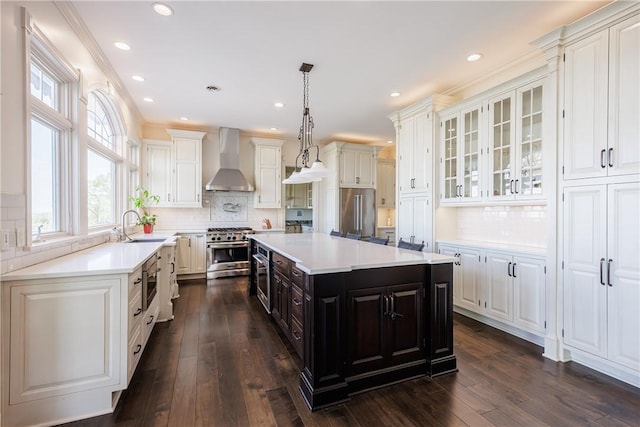 411 Sundance Trl, Webster, NY 14580 - kitchen featuring wall chimney range hood, premium appliances, white cabinetry, light countertops, and recessed lighting