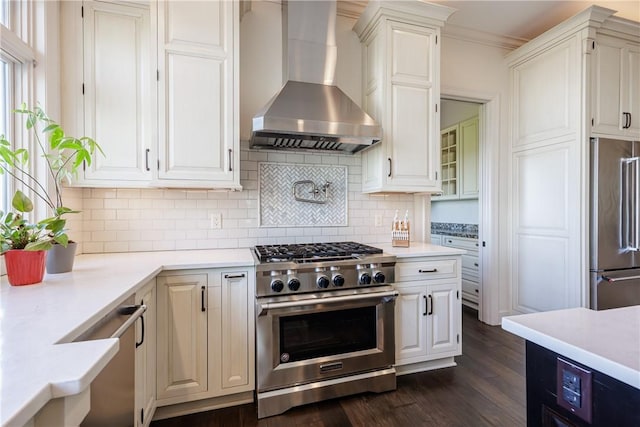 411 Sundance Trl, Webster, NY 14580 - kitchen featuring stainless steel appliances, wall chimney exhaust hood, light countertops, dark wood-style floors, and tasteful backsplash