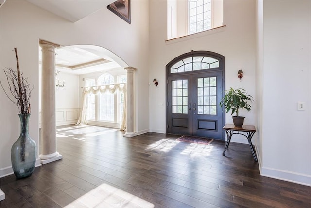 411 Sundance Trl, Webster, NY 14580 - entrance foyer featuring ornate columns, arched walkways, dark wood-style flooring, french doors, and baseboards