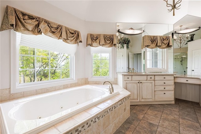 411 Sundance Trl, Webster, NY 14580 - full bath with vanity, a tub with jets, a stall shower, and stone finish floors