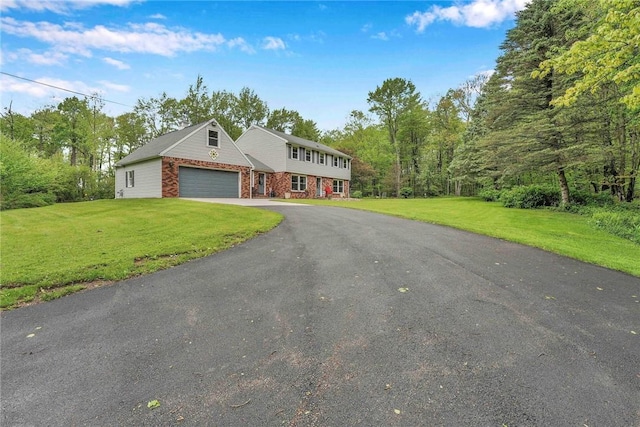 1338 Summit Rd, Foster-Town, PA 16744 - colonial home featuring an attached garage, asphalt driveway, and a front lawn