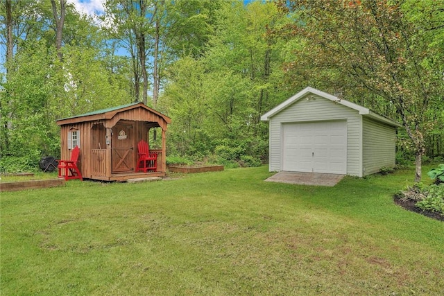 1338 Summit Rd, Foster-Town, PA 16744 - view of grassy yard featuring an outbuilding, a detached garage, and driveway
