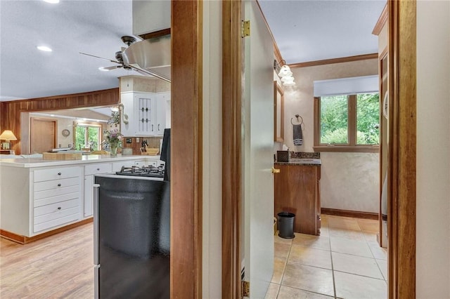 1338 Summit Rd, Foster Town, PA 16744 - kitchen with ceiling fan, white cabinetry, a peninsula, gas stovetop, and crown molding
