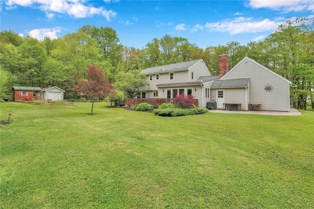 1338 Summit Rd, Foster-Town, PA 16744 - back of house featuring a lawn, a chimney, a deck, and an outdoor structure