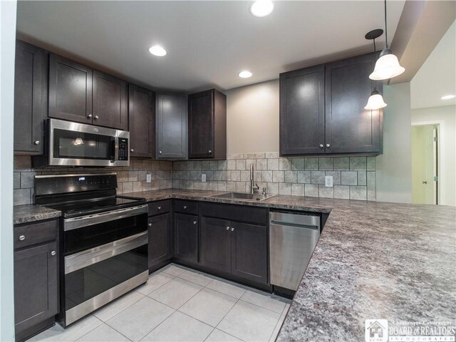 285 Porter Rd, Pomfret, NY 14063 - kitchen with appliances with stainless steel finishes, a sink, light tile patterned floors, backsplash, and hanging light fixtures