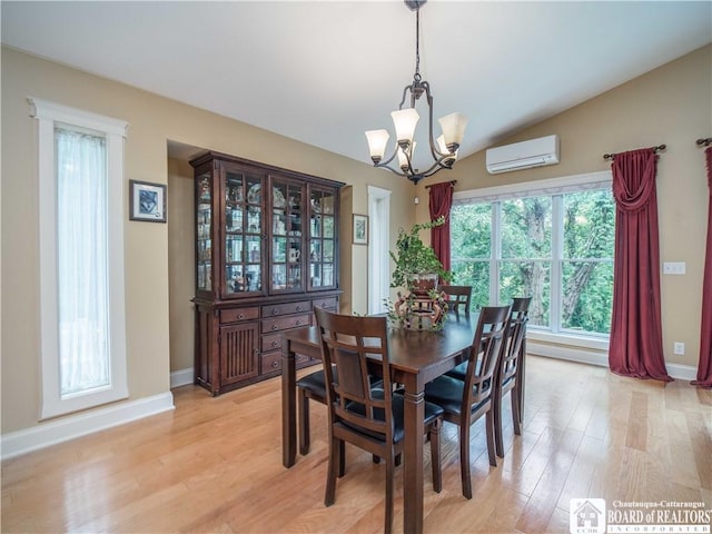285 Porter Rd, Pomfret, NY 14063 - dining area featuring a chandelier, a wall mounted AC, light wood-type flooring, baseboards, and vaulted ceiling