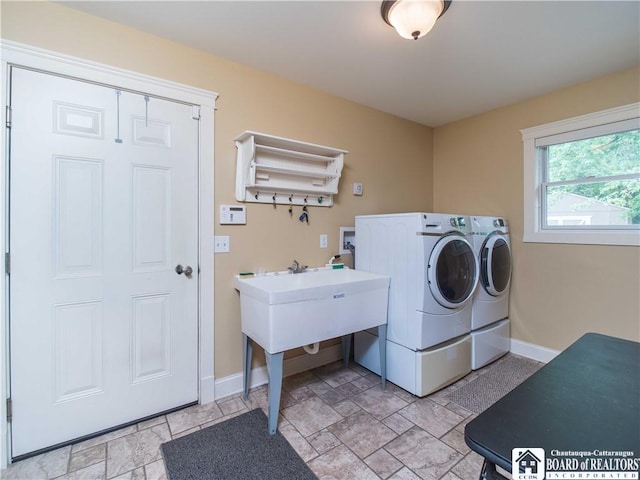 285 Porter Rd, Pomfret, NY 14063 - laundry area featuring separate washer and dryer, baseboards, and light stone finish floors