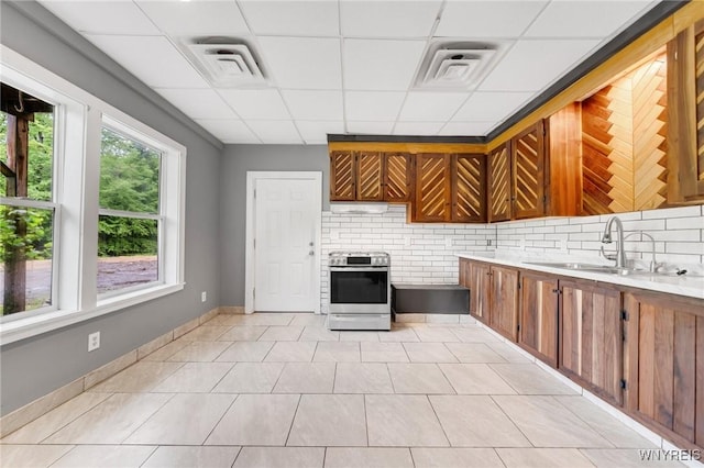 12353 Planck Rd, Perrysburg, NY 14129 - kitchen with stainless steel electric stove, a drop ceiling, brown cabinets, decorative backsplash, and a sink
