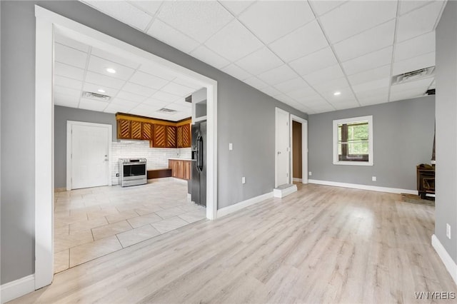 12353 Planck Rd, Perrysburg, NY 14129 - unfurnished living room with a paneled ceiling, light wood-style floors, and baseboards