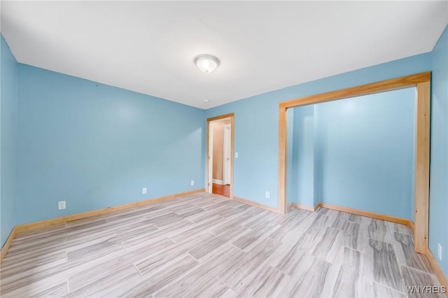 12353 Planck Rd, Perrysburg, NY 14129 - unfurnished bedroom featuring wood finished floors, baseboards, and a closet