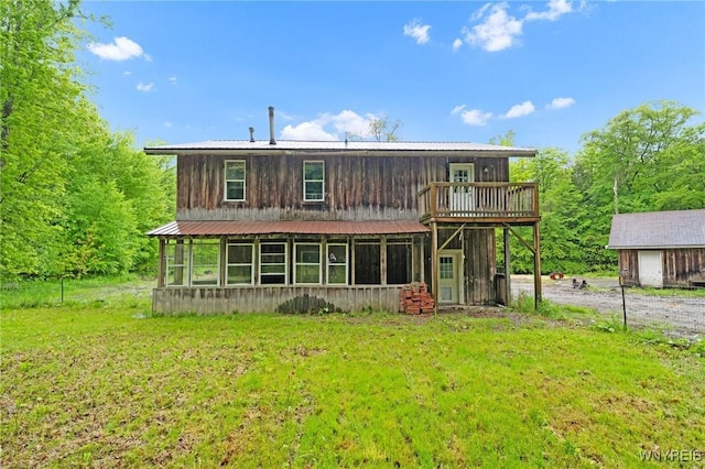 12353 Planck Rd, Perrysburg, NY 14129 - back of house featuring a sunroom, metal roof, and a yard