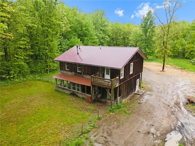 12353 Planck Rd, Perrysburg, NY 14129 - rear view of property featuring dirt driveway, a wooded view, metal roof, and a wooden deck