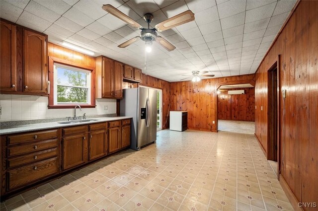 4064 Kayuta Ter, Forestport, NY 13438 - kitchen with stainless steel fridge with ice dispenser, a sink, ceiling fan, brown cabinetry, and light countertops
