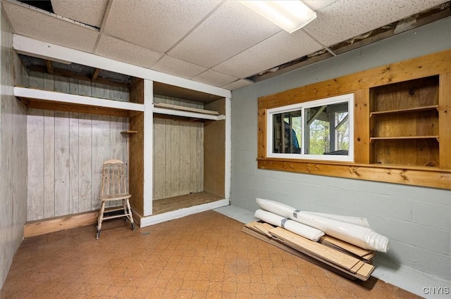 4064 Kayuta Ter, Forestport, NY 13438 - below grade area featuring tile patterned floors, a paneled ceiling, and wood walls