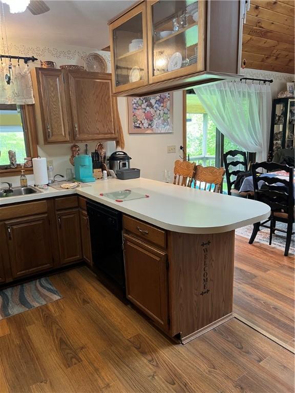 3259 Freer Hollow Rd, Franklin, NY 13856 - kitchen featuring a peninsula, dishwasher, dark wood-style flooring, light countertops, and a sink