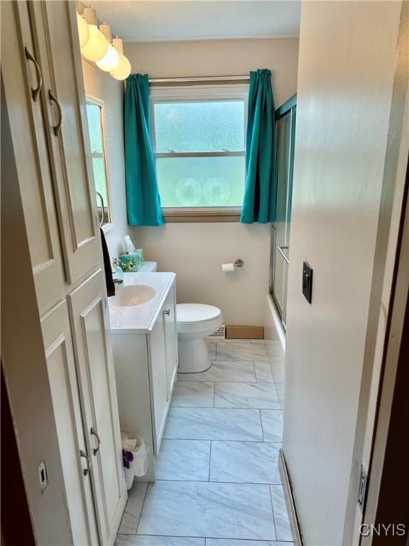 6302 Meadow Dr, Lee, NY 13440 - full bathroom with vanity, marble look tile flooring, toilet, and bath / shower combo with glass door