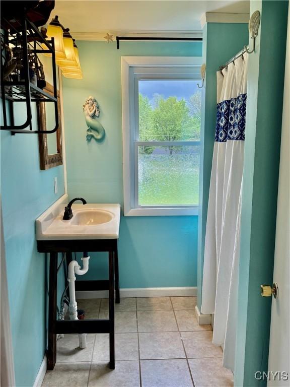 6302 Meadow Dr, Lee, NY 13440 - full bathroom featuring tile patterned floors, a sink, baseboards, ornamental molding, and curtained shower