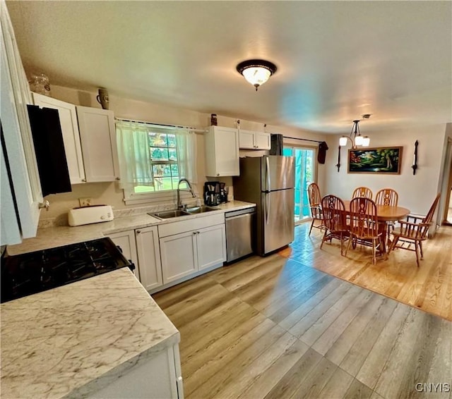 6302 Meadow Dr, Lee, NY 13440 - kitchen with a sink, appliances with stainless steel finishes, plenty of natural light, and white cabinets
