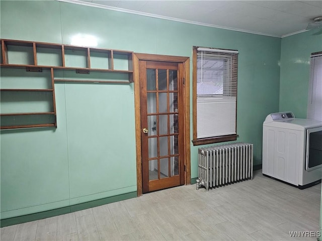 2207 Linwood Ave, Niagara Falls, NY 14305 - laundry area featuring washer / clothes dryer, radiator heating unit, crown molding, and wood finished floors