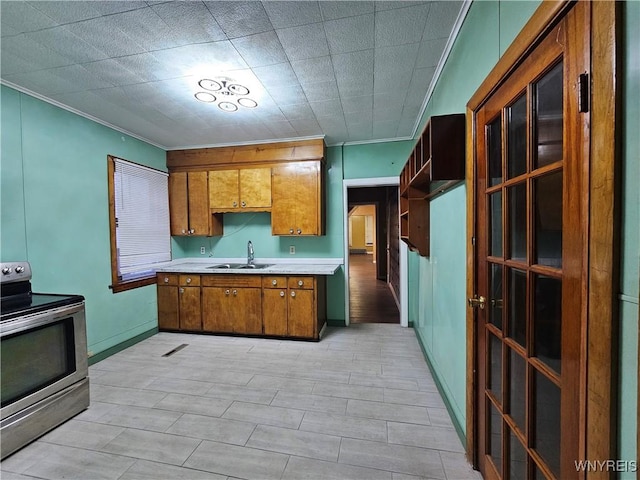 2207 Linwood Ave, Niagara Falls, NY 14305 - kitchen with stainless steel range with electric cooktop, a sink, brown cabinets, light countertops, and ornamental molding