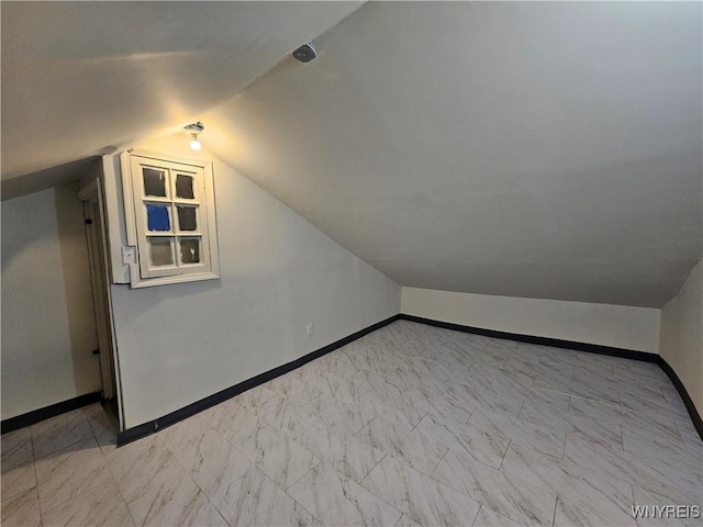 2207 Linwood Ave, Niagara Falls, NY 14305 - bonus room featuring vaulted ceiling, baseboards, and light marble finish floors