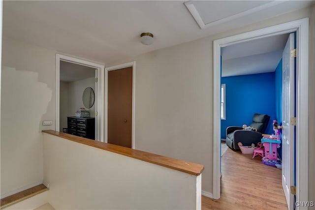 163 Maple St, Le Ray, NY 13612 - hallway with light wood-type flooring, baseboards, and attic access