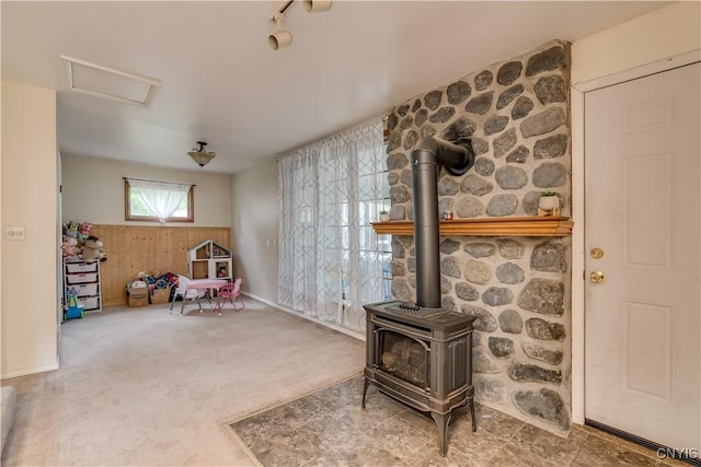 163 Maple St, Le Ray, NY 13612 - game room featuring a wood stove, carpet flooring, and attic access