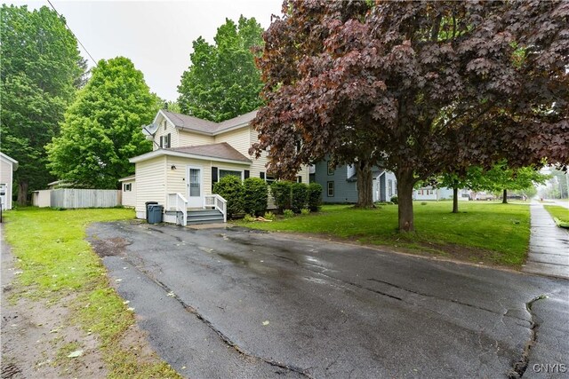 163 Maple St, Le Ray, NY 13612 - view of front of property with a front yard, asphalt driveway, and roof with shingles