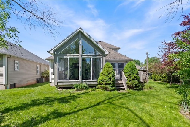 763 Bel Arbor Trl, Webster, NY 14580 - rear view of house with a sunroom, a wooden deck, a lawn, and cooling unit