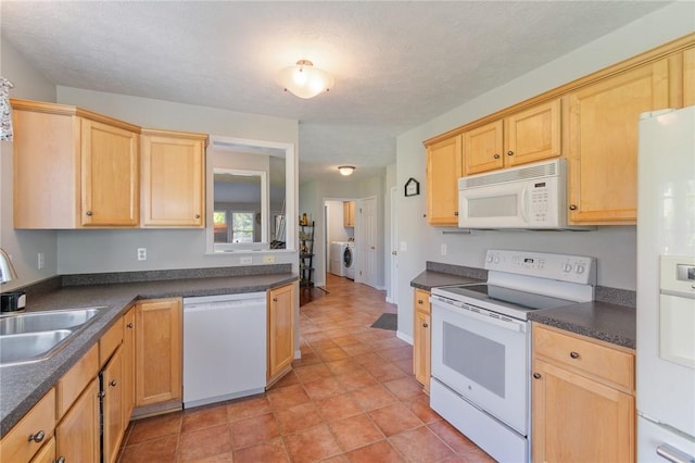 763 Bel Arbor Trl, Webster, NY 14580 - kitchen featuring white appliances, a sink, light brown cabinetry, washer / clothes dryer, and dark countertops