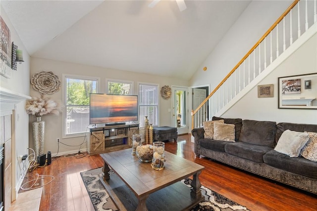 763 Bel Arbor Trl, Webster, NY 14580 - living room with hardwood / wood-style floors, a ceiling fan, a fireplace, high vaulted ceiling, and stairs