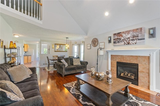 763 Bel Arbor Trl, Webster, NY 14580 - living area with a fireplace, dark wood finished floors, high vaulted ceiling, baseboards, and recessed lighting