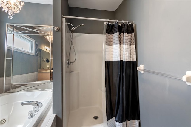 763 Bel Arbor Trl, Webster, NY 14580 - bathroom featuring a stall shower, a tub with jets, and a chandelier