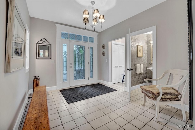 1225 W Arnold Dr, Hamburg, NY 14085 - entrance foyer with a chandelier, light tile patterned floors, and baseboards
