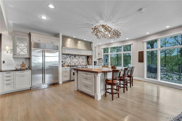 1225 W Arnold Dr, Hamburg, NY 14085 - kitchen with high end appliances, light wood finished floors, butcher block counters, recessed lighting, and a breakfast bar