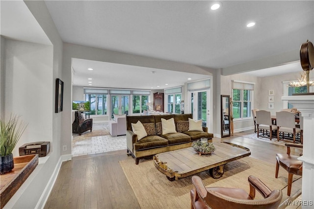 1225 W Arnold Dr, Hamburg, NY 14085 - living room featuring baseboards, recessed lighting, plenty of natural light, wood finished floors, and a chandelier