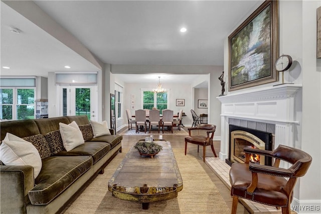 1225 W Arnold Dr, Hamburg, NY 14085 - living room with plenty of natural light, a chandelier, a fireplace, light wood-style floors, and recessed lighting
