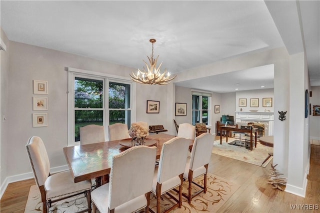 1225 W Arnold Dr, Hamburg, NY 14085 - dining area with wood finished floors, plenty of natural light, and a chandelier