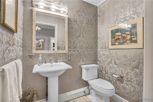 1225 W Arnold Dr, Hamburg, NY 14085 - half bathroom featuring wallpapered walls, toilet, baseboards, tile patterned flooring, and a sink