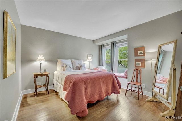 1225 W Arnold Dr, Hamburg, NY 14085 - bedroom with wood-type flooring, baseboards, and access to exterior