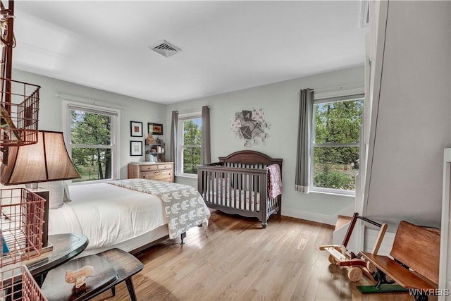 1225 W Arnold Dr, Hamburg, NY 14085 - bedroom with multiple windows, wood finished floors, and baseboards