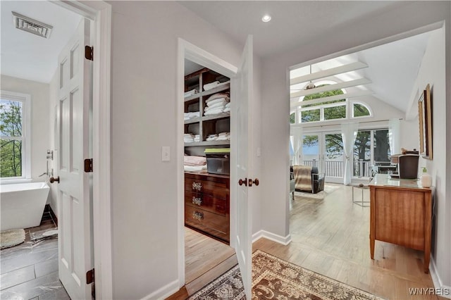 1225 W Arnold Dr, Hamburg, NY 14085 - hall featuring vaulted ceiling, light wood-style floors, and baseboards