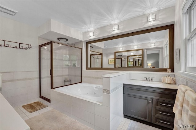 1225 W Arnold Dr, Hamburg, NY 14085 - bathroom featuring a shower stall, a jetted tub, tile patterned flooring, and vanity