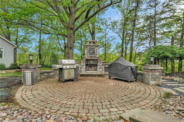 1225 W Arnold Dr, Hamburg, NY 14085 - view of patio featuring an outdoor stone fireplace and a grill