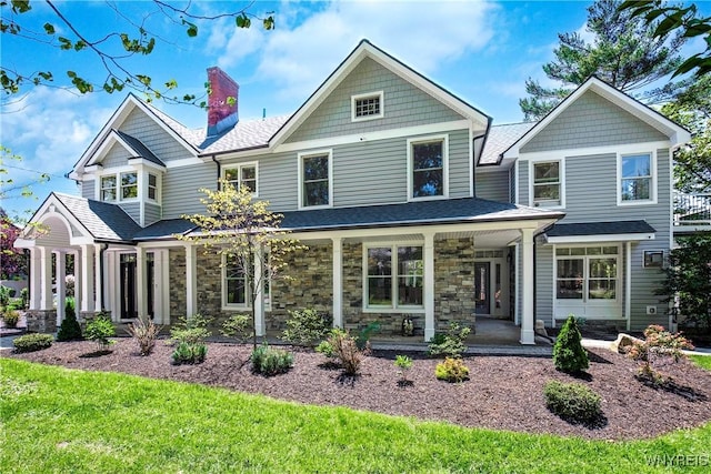 1225 W Arnold Dr, Hamburg, NY 14085 - view of front facade featuring a chimney, a shingled roof, and stone siding