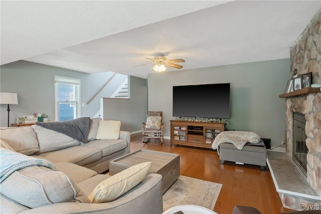 229 Brookfield Rd, Salina, NY 13211 - living area with stairway, a fireplace, ceiling fan, and wood finished floors